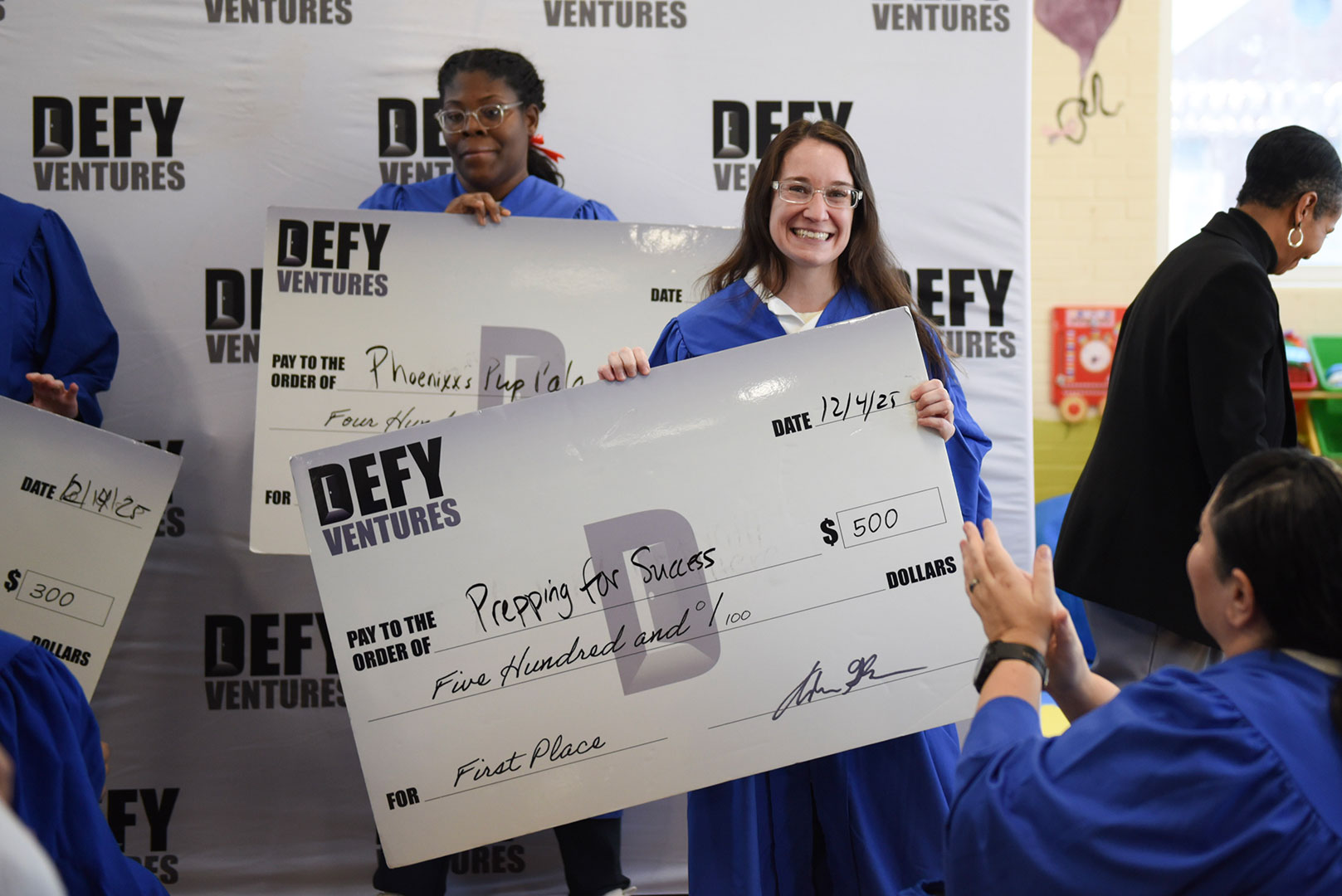 Winner Briana accepting her check for her company Prepping for Success